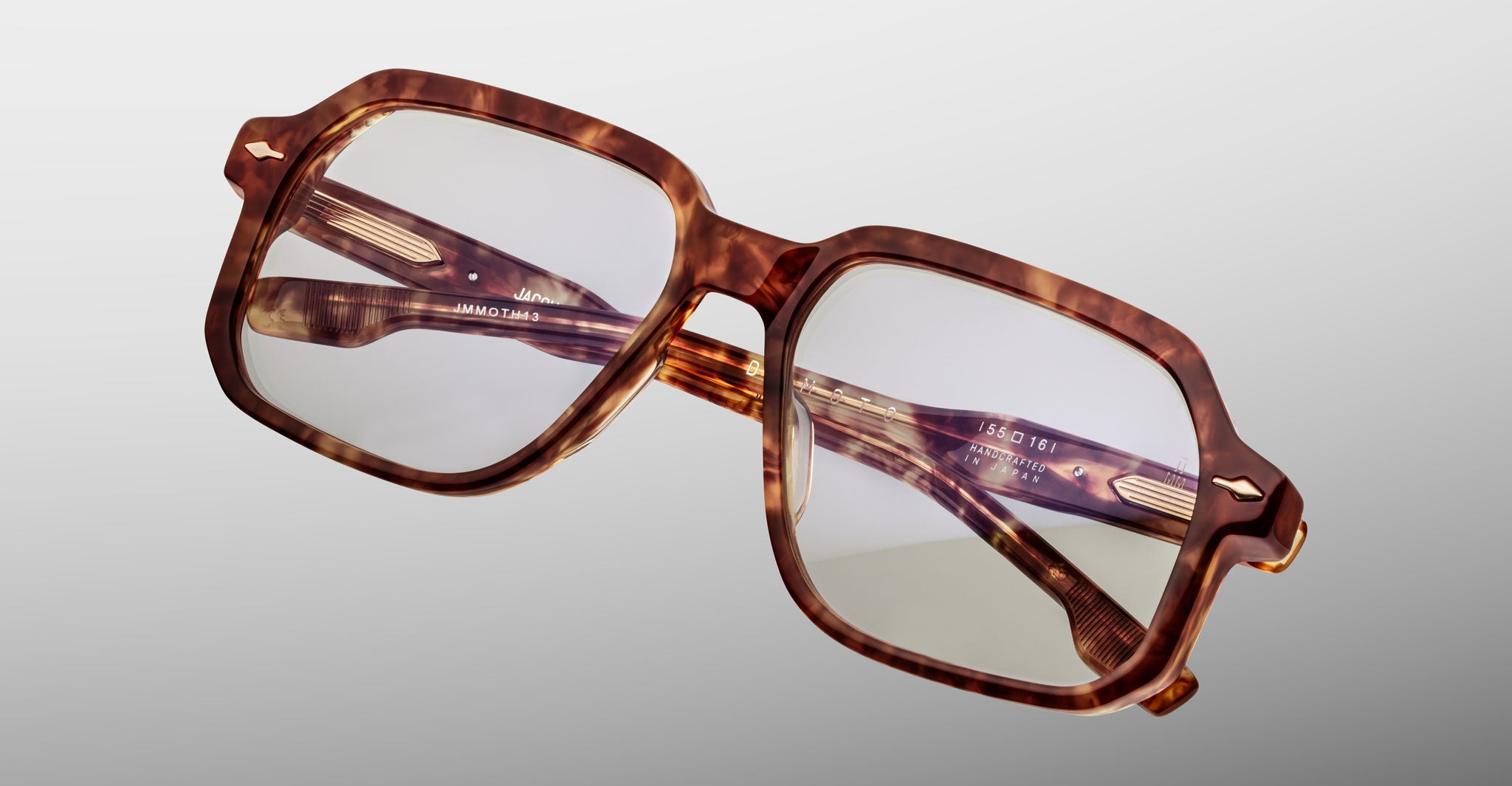 Jacques Marie Mage Domoto tortoiseshell square eyeglasses with thick frames and clear lenses, handcrafted in Japan, shown against a plain light gray background.