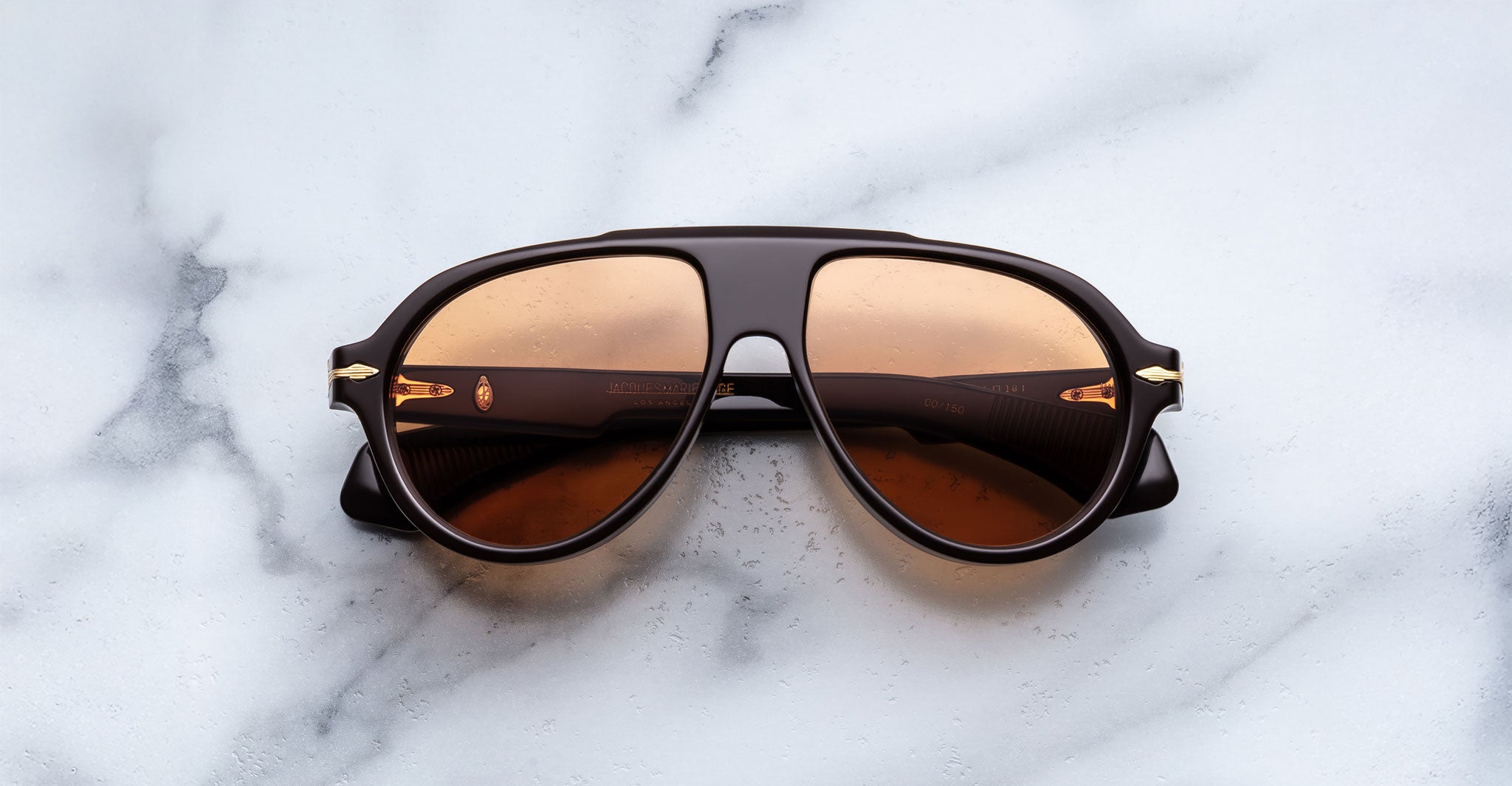 Jacques Marie Mage Donnybrooke in Walnut aviator sunglasses in brown with amber-tinted lenses, shown from a top-down angle.