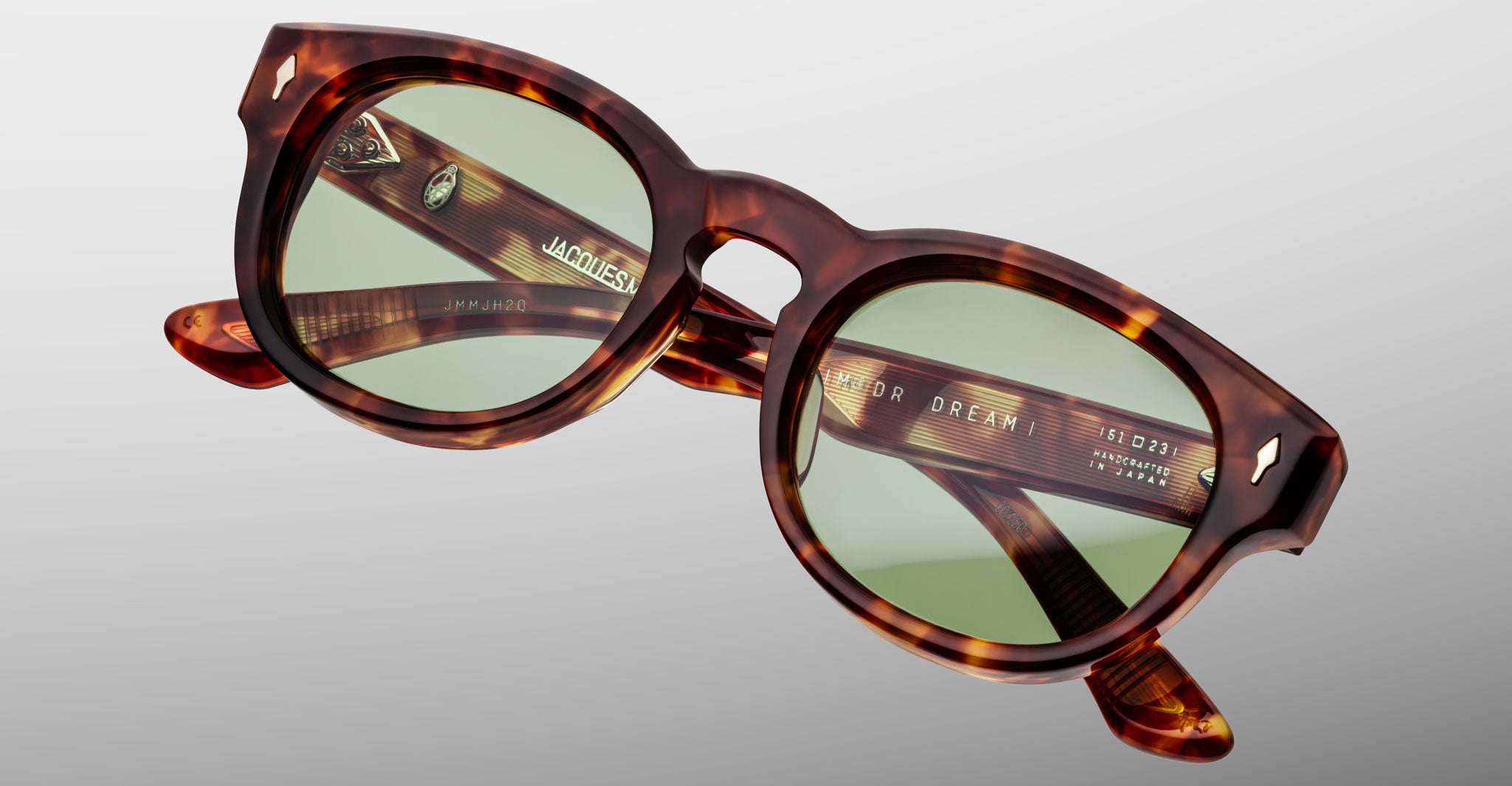 Jacques Marie Mage Dr Dream in Baltic tortoiseshell sunglasses with green tinted lenses, shown at an angled side view.