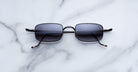 Jacques Marie Mage Dusk black polarized sunglasses with dark lenses, top view.