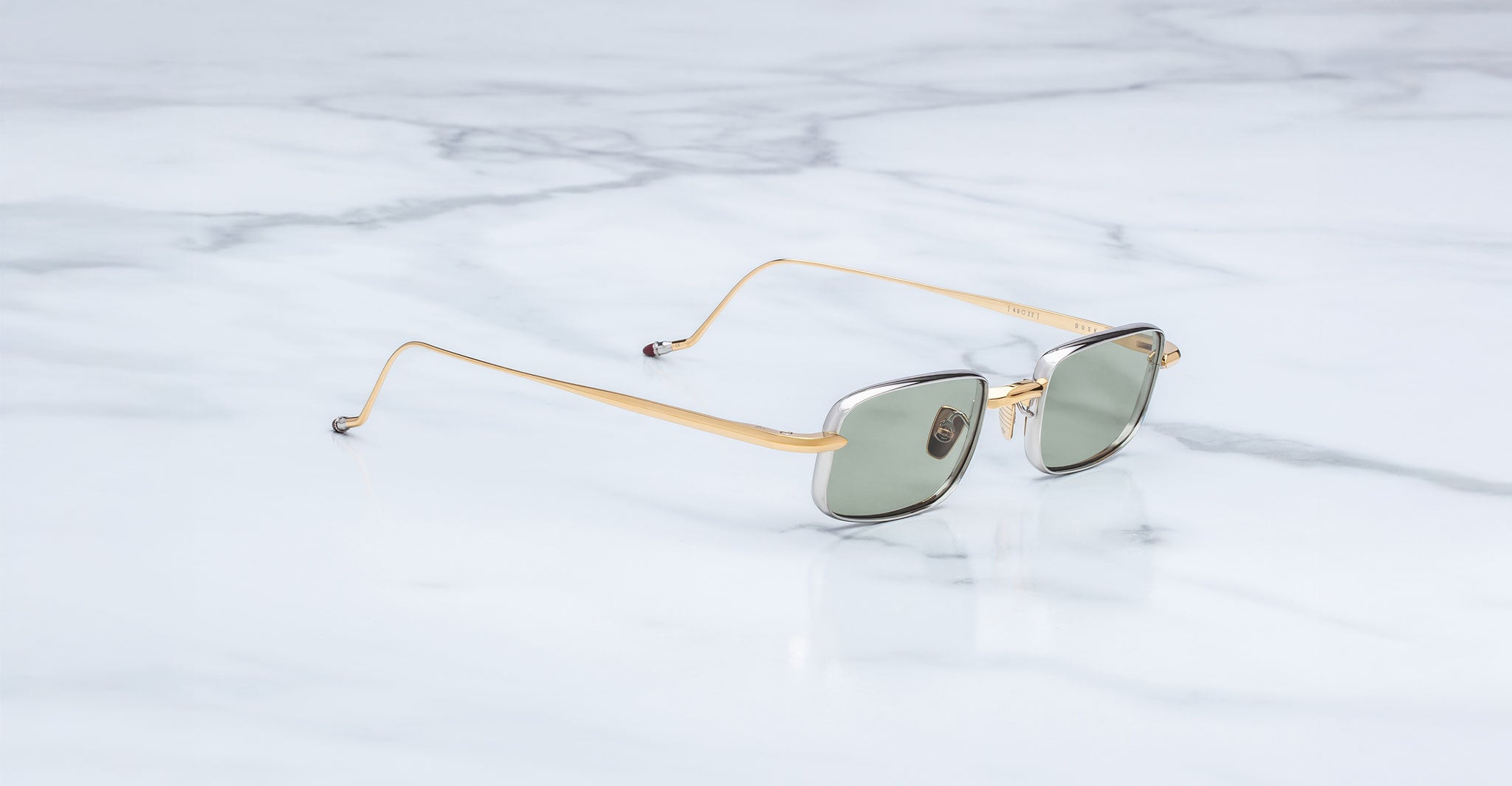Jacques Marie Mage Dusk sunglasses, green lenses, gold frames, top view.