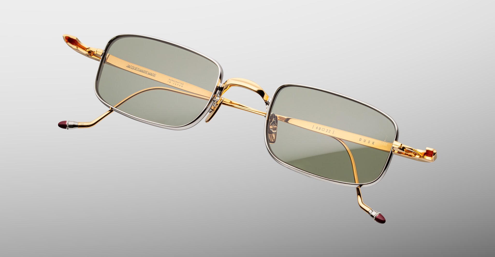 Jacques Marie Mage Dusk sunglasses with rectangular gold frames and green lenses, shown from the front.