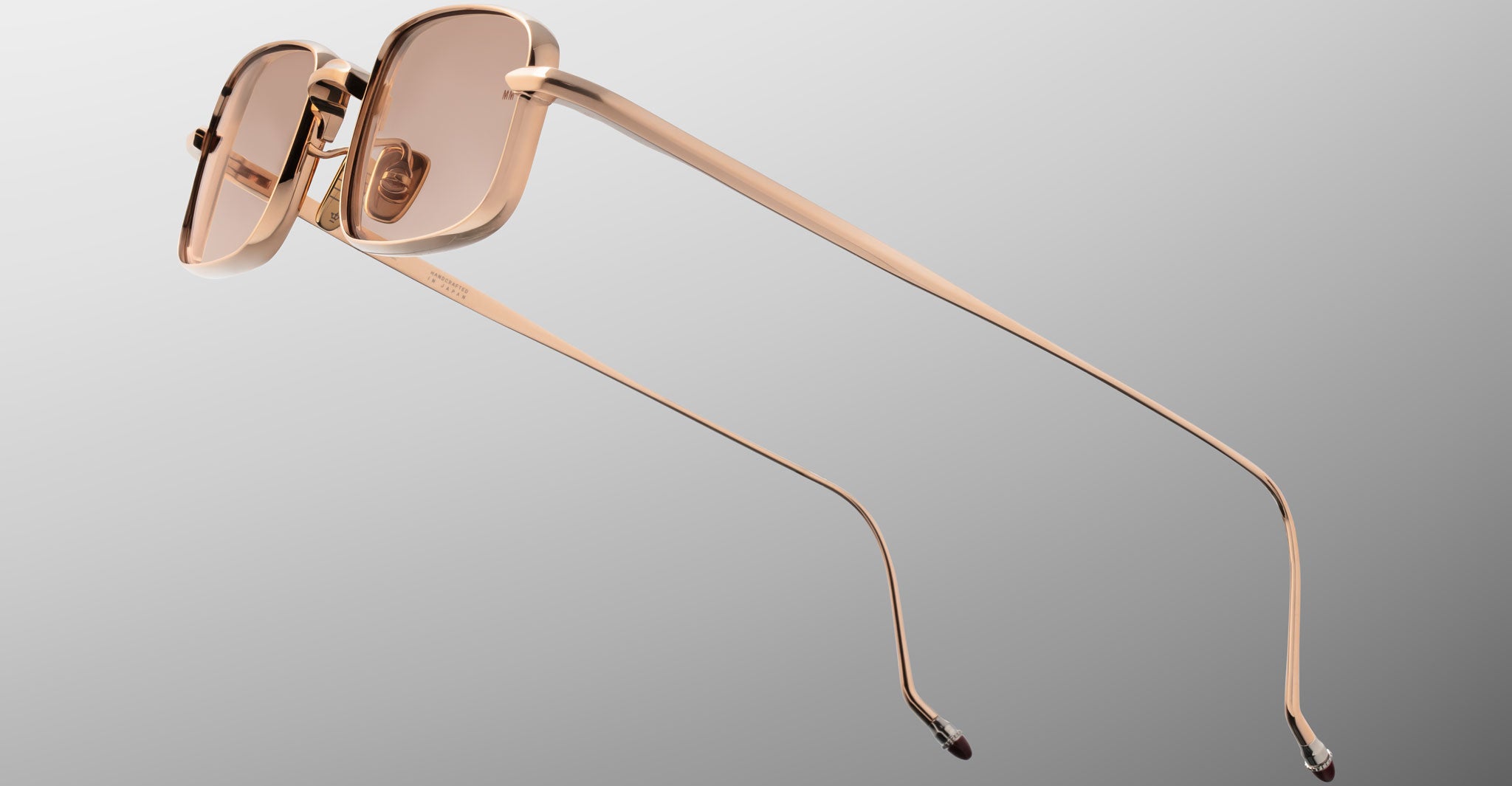 Jacques Marie Mage Dusk sunglasses, rose gold rectangular frame with pink lenses, viewed from the back.