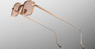 Jacques Marie Mage Dusk sunglasses, rose gold rectangular frame with pink lenses, viewed from the back.