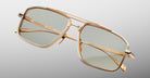 Jacques Marie Mage Earl sunglasses, gold rectangular frame with green lenses, front view.