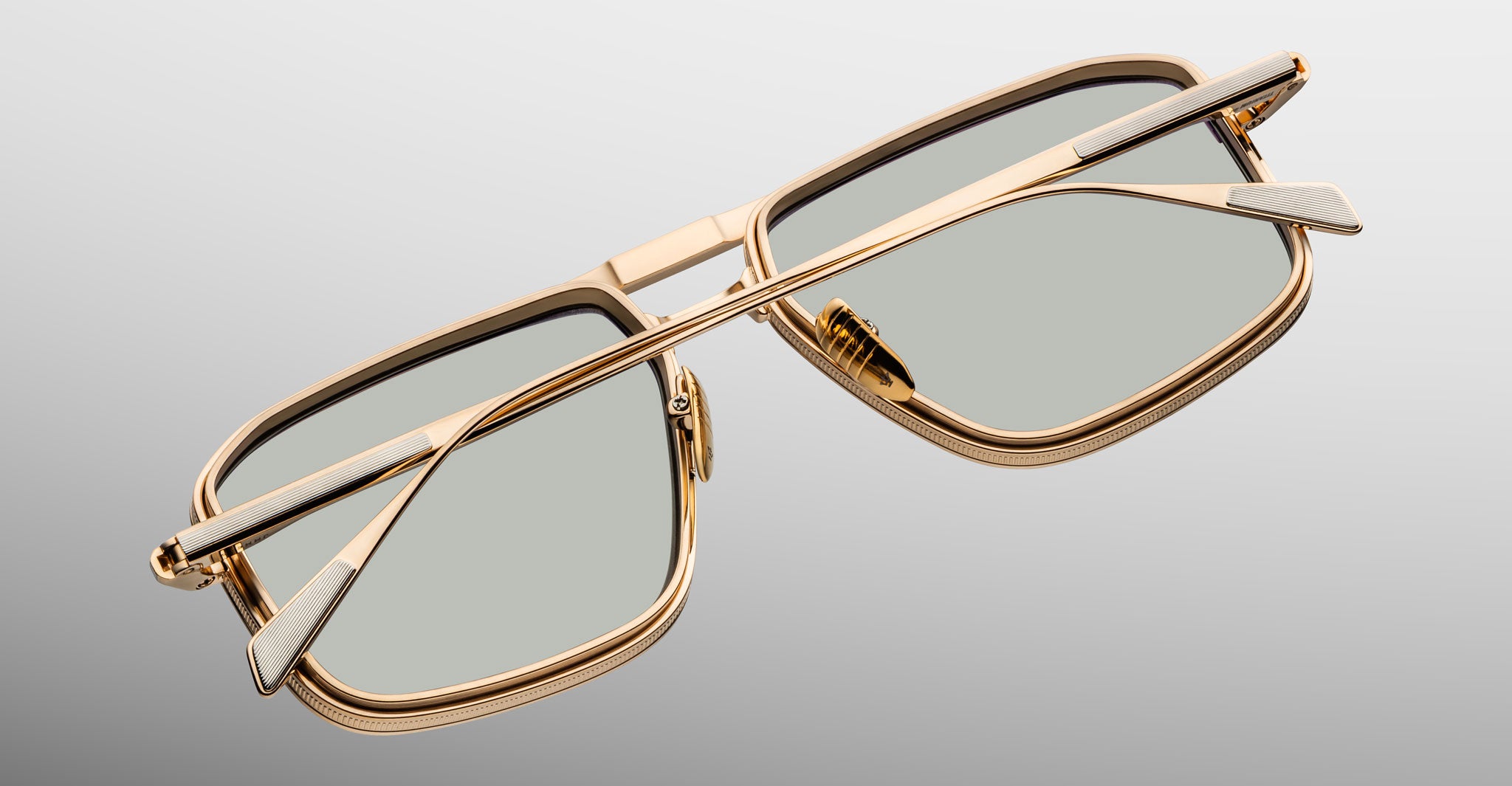 Jacques Marie Mage Earl gold rectangular sunglasses with gray polarized lenses, shown from a rear angled view.