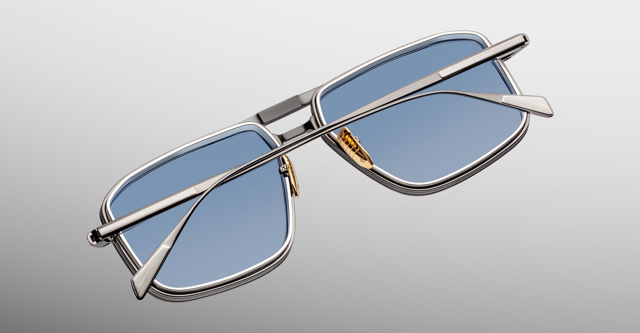 Jacques Marie Mage Earl sunglasses with rectangular blue-tinted lenses and silver metal frame, viewed from the back.