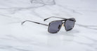 Jacques Marie Mage Earl black rectangular sunglasses with dark lenses, top view.