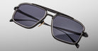 Jacques Marie Mage Earl rectangular black metal-frame sunglasses with UV-protection dark lenses, shown from a front angle.