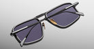 Jacques Marie Mage Earl sunglasses, rectangular black frames, dark lenses, silver details, gold nose pads, front-facing view.