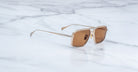 Jacques Marie Mage Earl gold aviator sunglasses with brown lenses, shown from above.