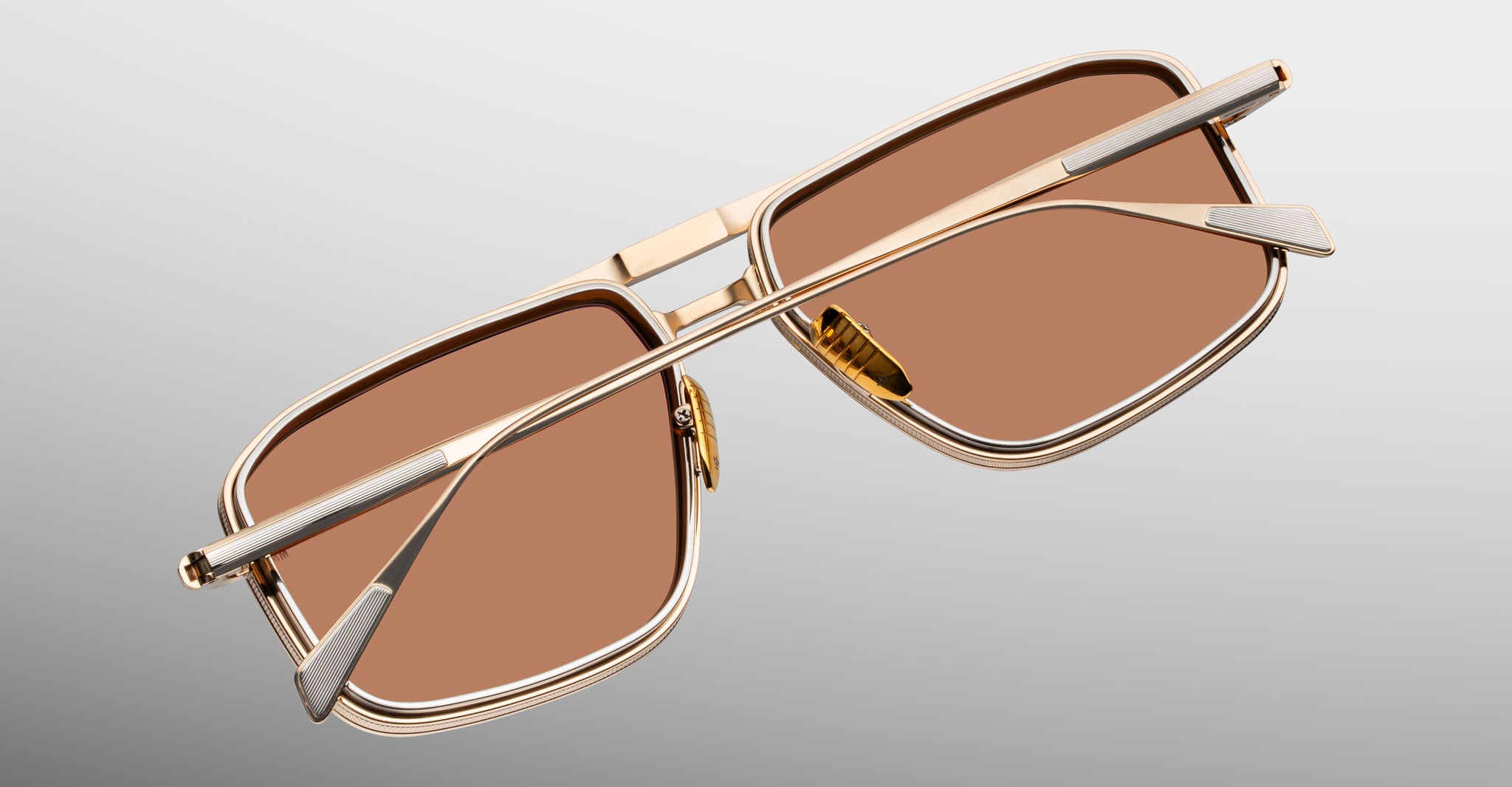 Jacques Marie Mage Earl gold sunglasses with brown lenses, viewed from the back, showing frame and temples.
