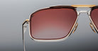 Close-up of Jacques Marie Mage Earl sunglasses featuring gold accents and red-tinted lenses, front view.