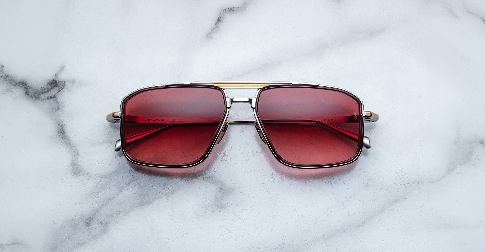Jacques Marie Mage Earl aviator sunglasses with red-tinted lenses shown from above; product type is sunglasses.