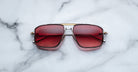 Jacques Marie Mage Earl aviator sunglasses with red-tinted lenses shown from above; product type is sunglasses.