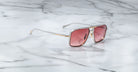 Jacques Marie Mage Earl sunglasses with square frames and pink lenses, front view.