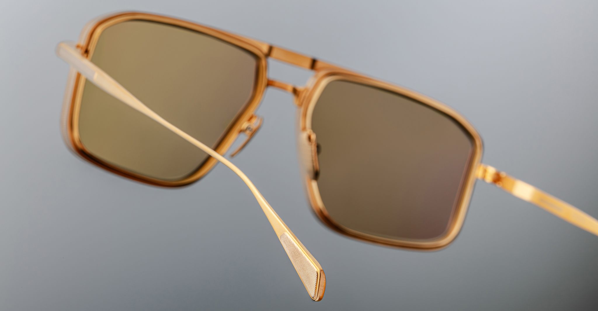 Close-up of Jacques Marie Mage Earl sunglasses, gold frame, brown lenses, front view.