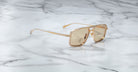 Jacques Marie Mage Earl gold aviator sunglasses with light brown lenses, front view displayed.