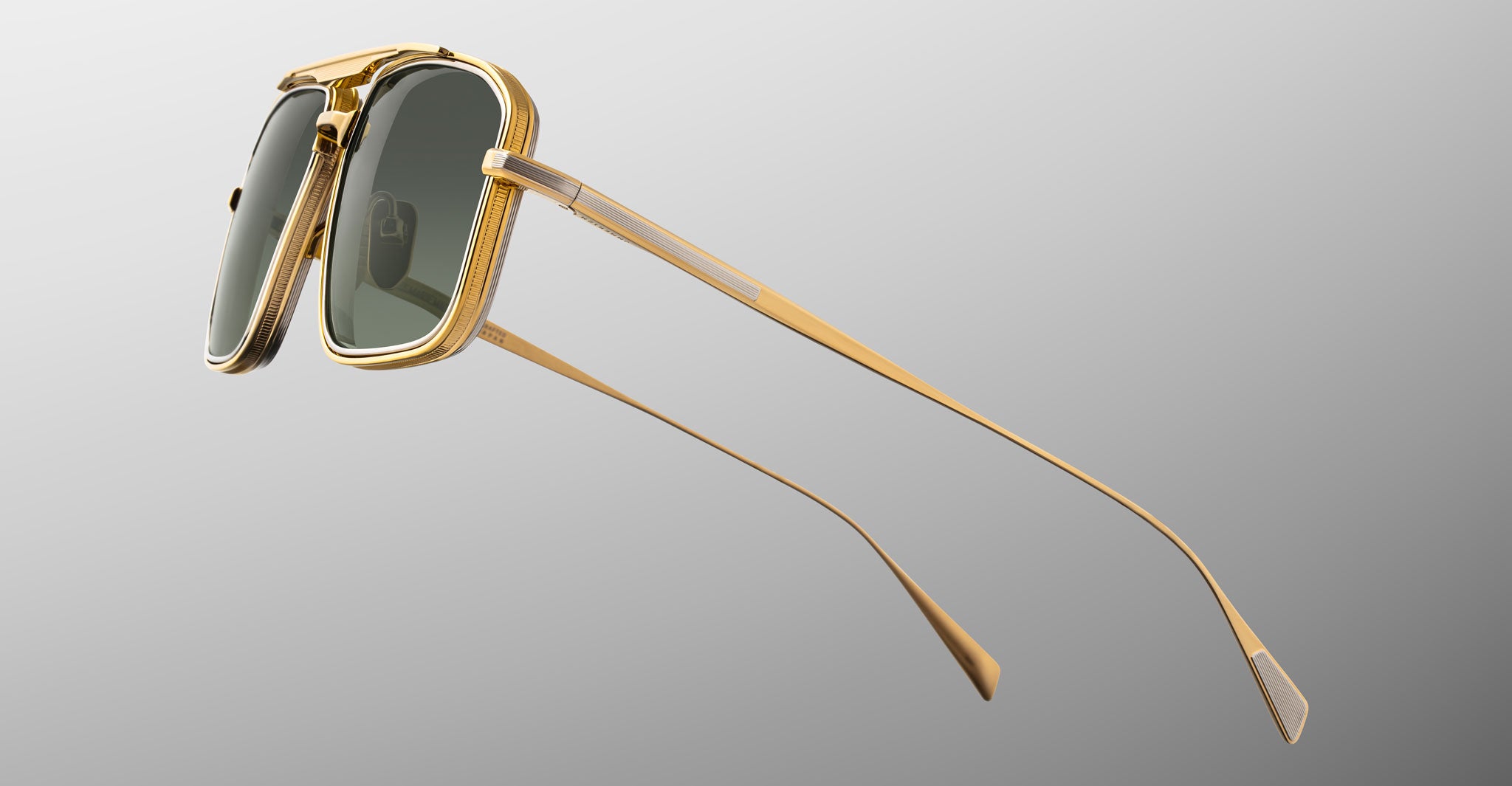 The Jacques Marie Mage Earl sunglasses showcase a sleek gold frame with dark tinted lenses, Art Deco details, and thin elegant arms in a minimalist modern style, displayed at an angle on a gradient gray background.
