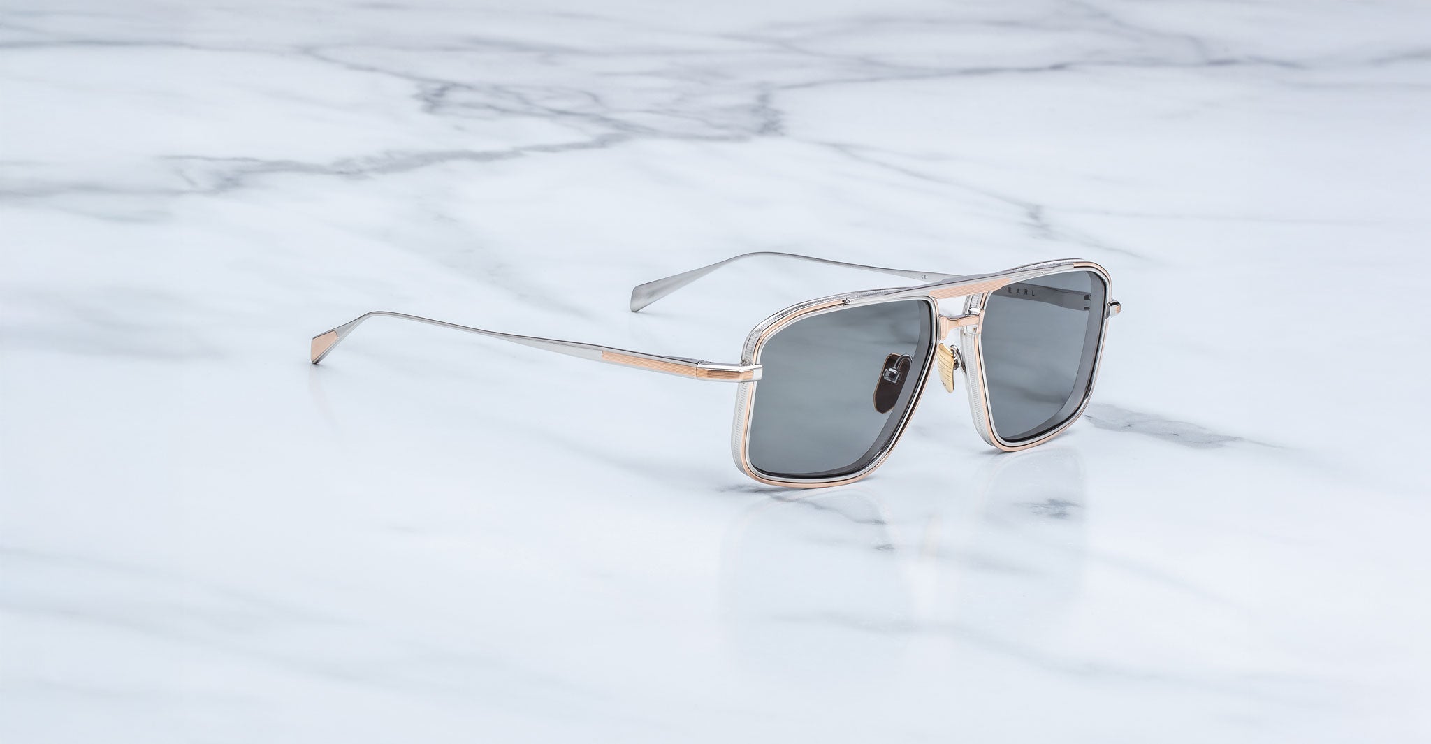 Jacques Marie Mage Earl aviator sunglasses with silver frames and dark lenses, top view.