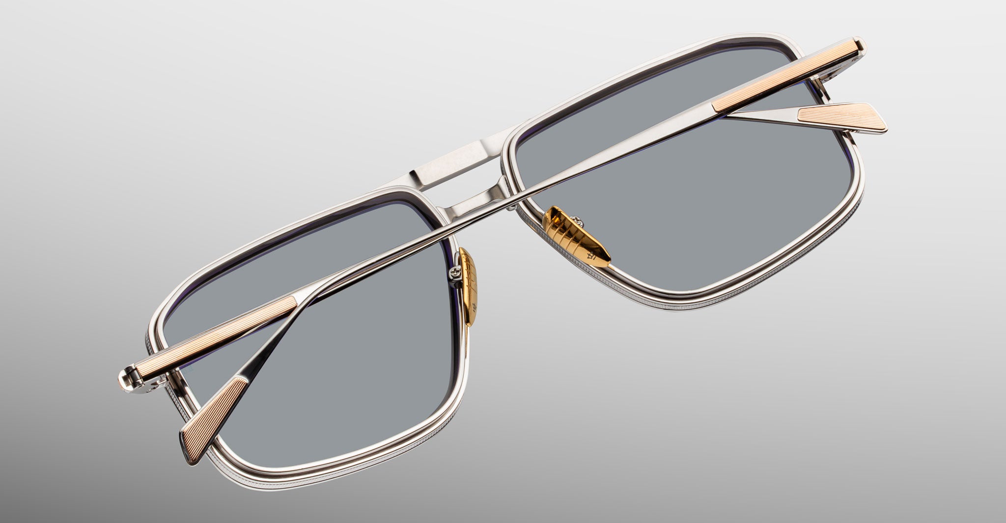 Jacques Marie Mage Earl rectangular silver sunglasses with gold temples, shown from the front.
