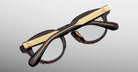 Jacques Marie Mage Eiko tortoiseshell eyeglasses with gold temples, shown folded, side view.
