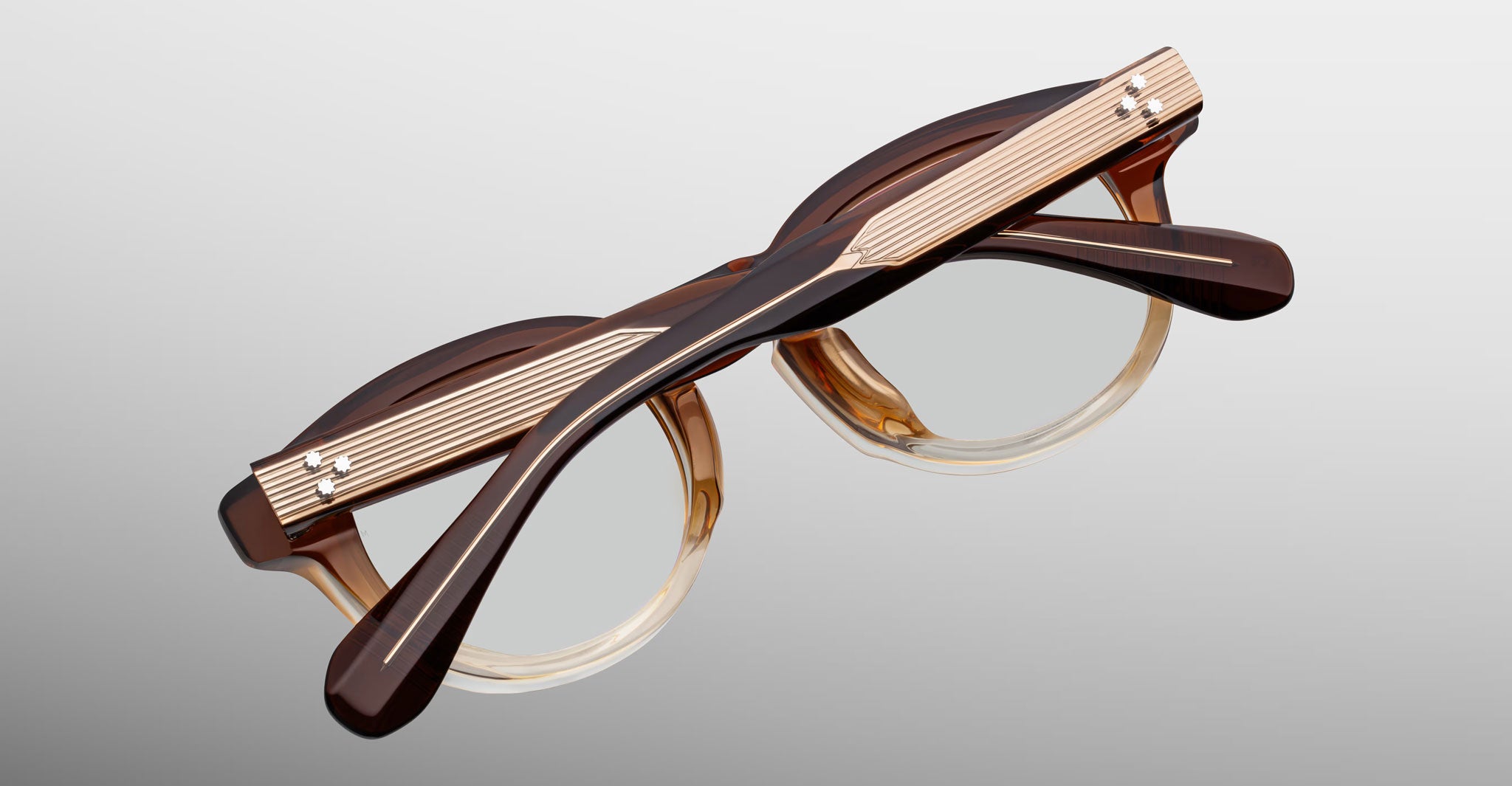 Jacques Marie Mage Eiko eyeglasses, brown and beige thick frame, crossed arms visible, front angle.