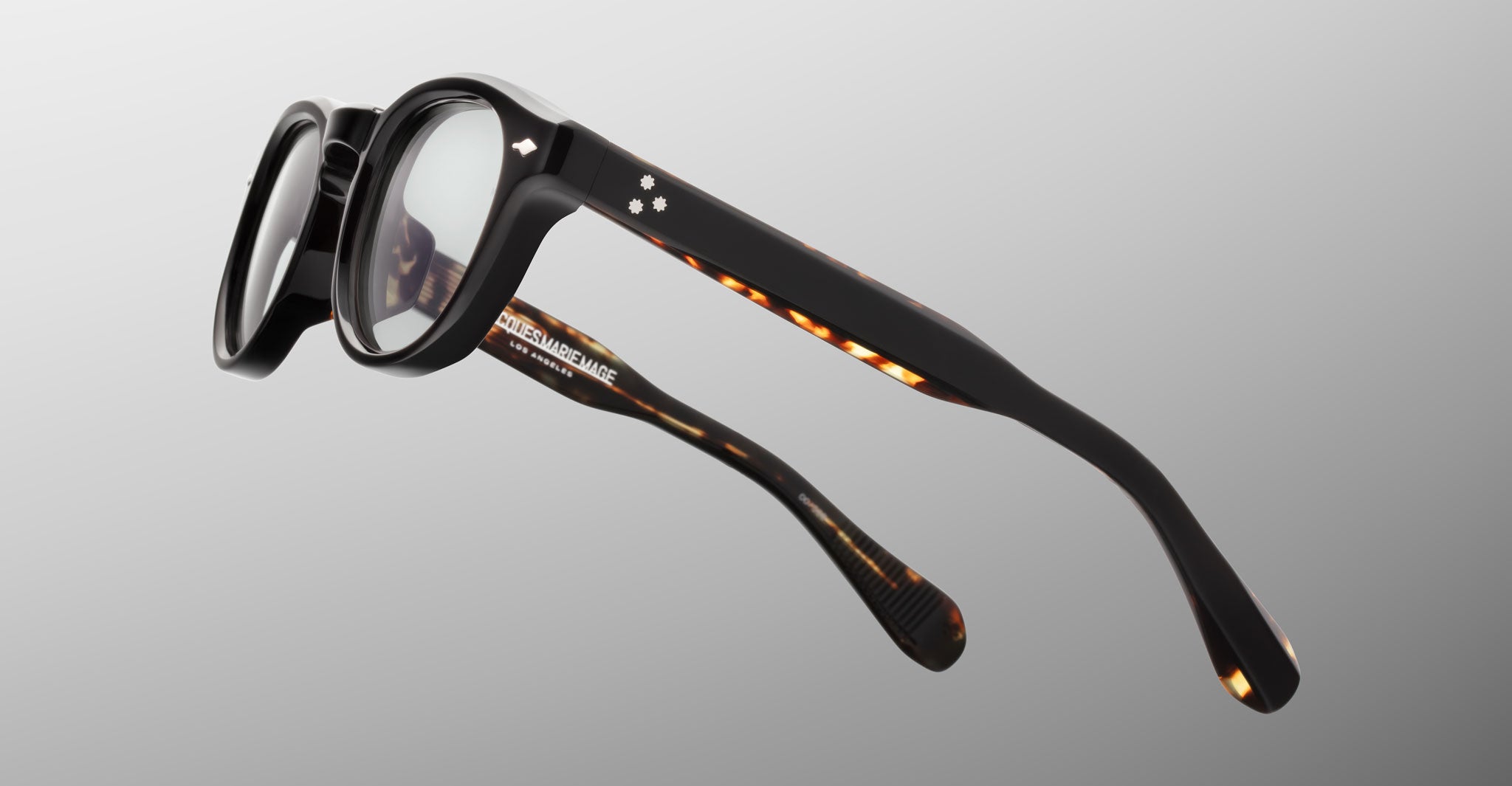 Jacques Marie Mage Eiko black round eyeglasses with tortoiseshell arms, slim frame, front angle.