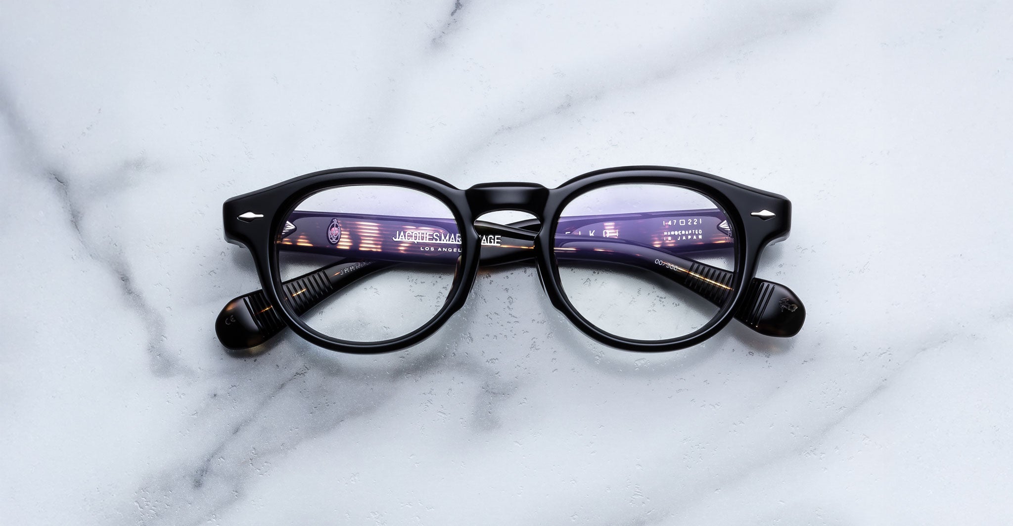 Jacques Marie Mage Eiko black round eyeglasses with anti-glare lenses, top view.