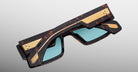 Jacques Marie Mage Engel sunglasses, tortoiseshell frame, gold accents, blue lenses, front view.
