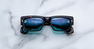 Jacques Marie Mage Engel black rectangular sunglasses with blue mirrored lenses, front angle.