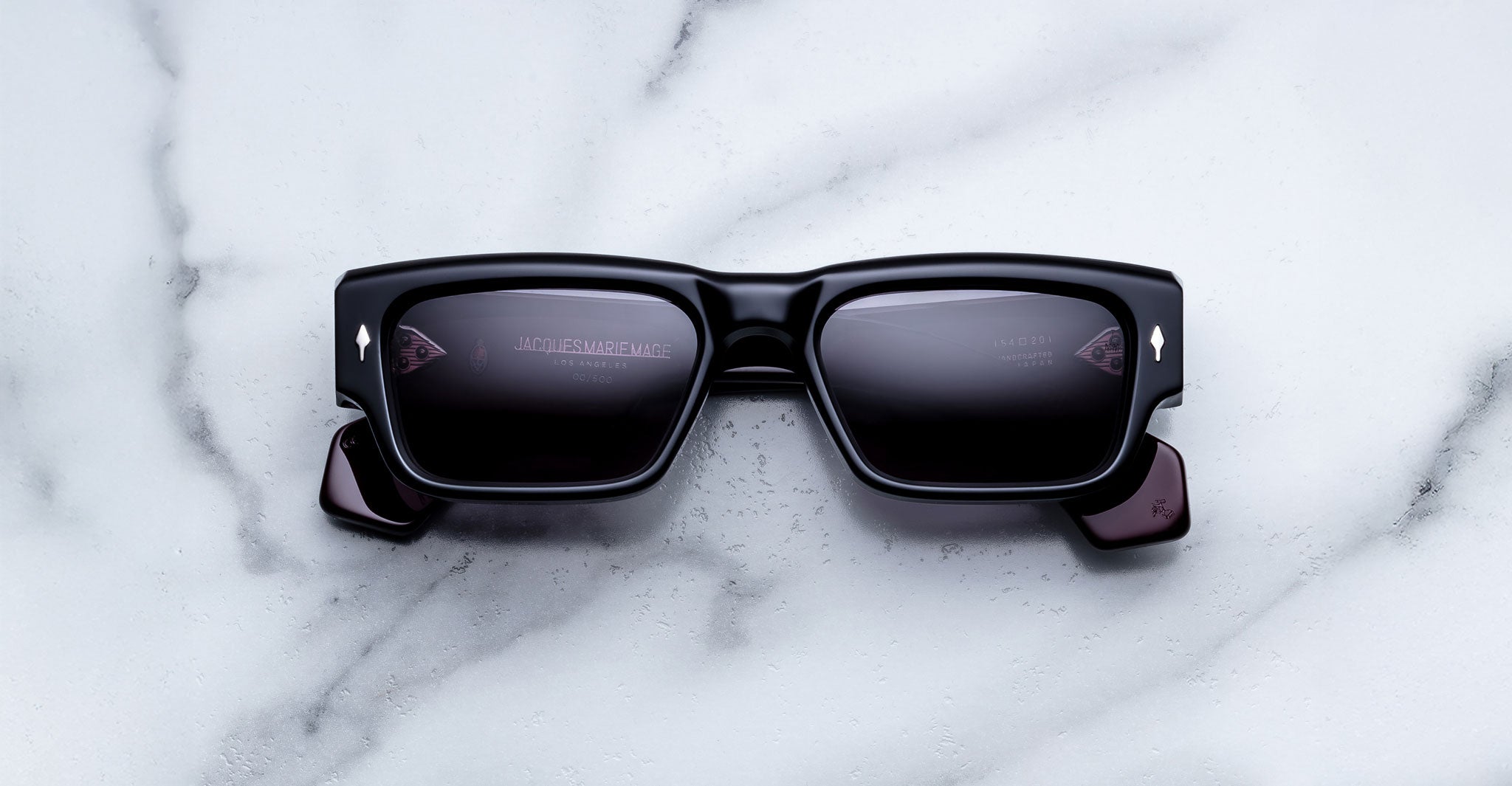 Jacques Marie Mage Engel black rectangular sunglasses with UV lenses, top view.