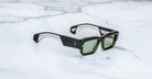 Jacques Marie Mage Engel sunglasses shown with green lenses, top-down view.