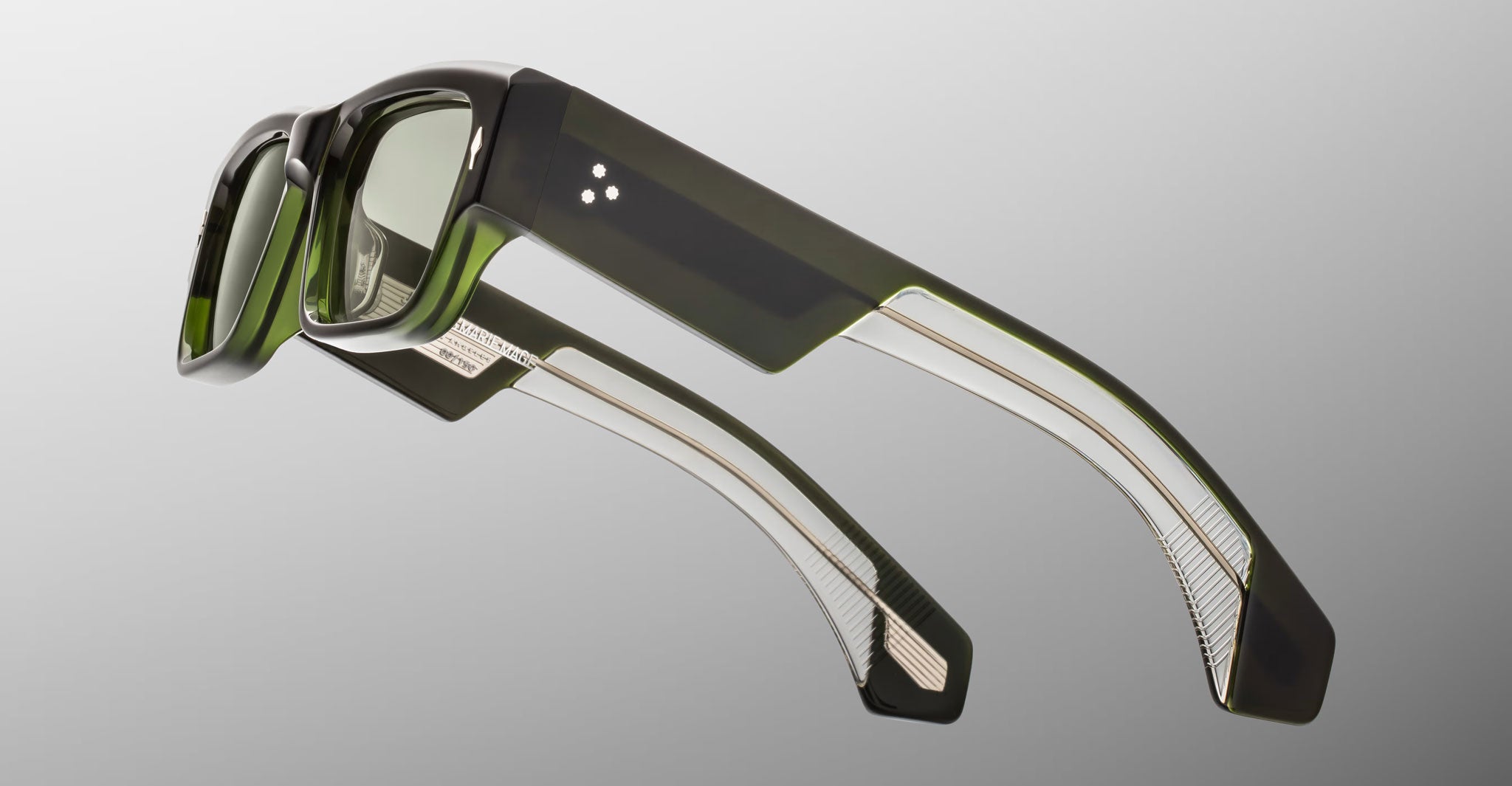 Jacques Marie Mage Engel sunglasses, front view, thick dark green frames, translucent tips, subtle metallic accents.