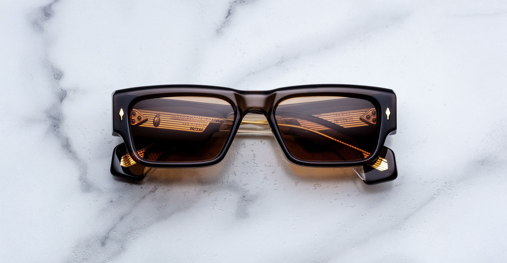 Jacques Marie Mage Engel rectangular black sunglasses with brown lenses, top view.