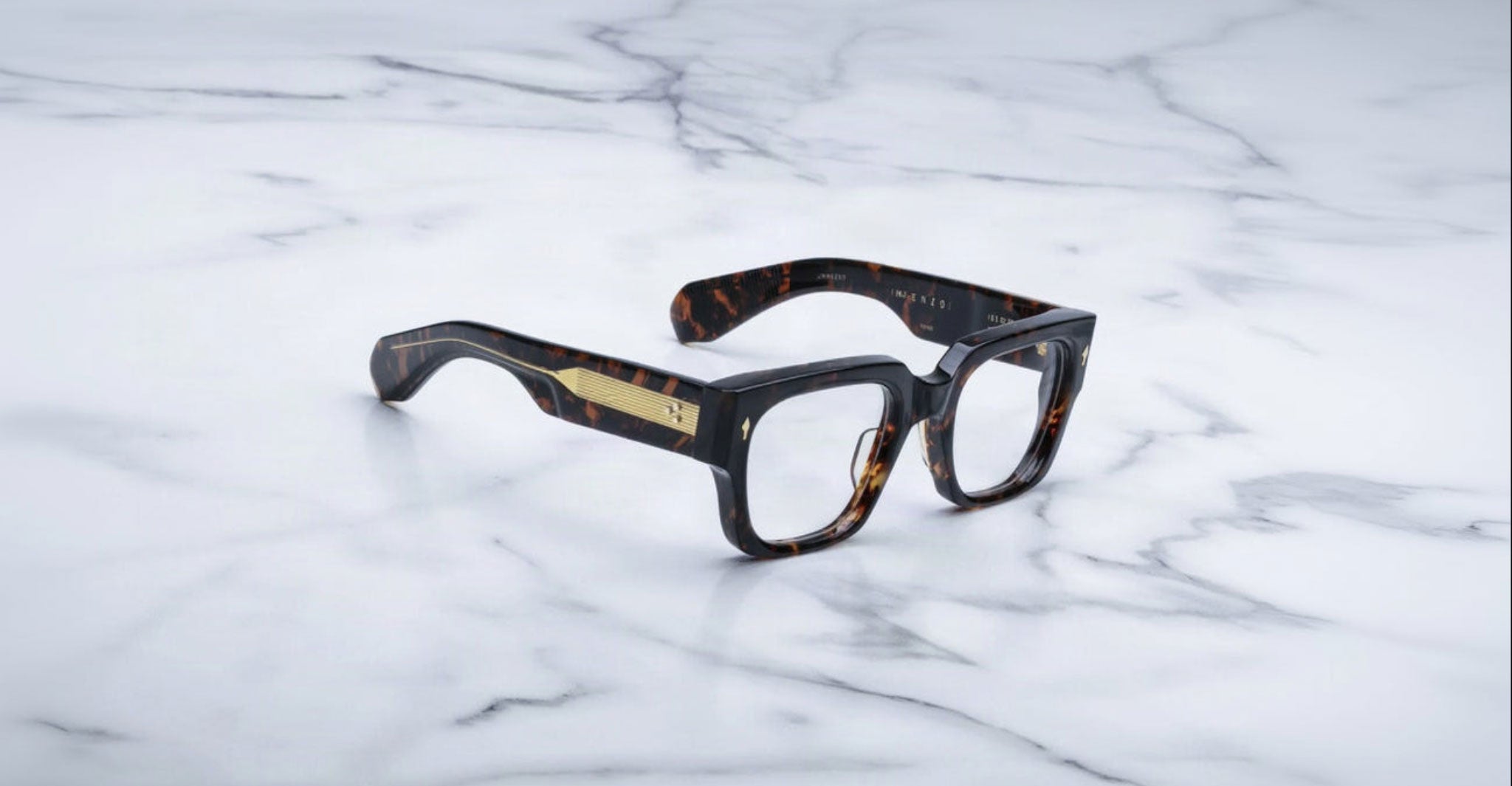 Jacques Marie Mage Enzo eyeglasses with gold-detailed arms, shown from above.