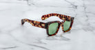 Jacques Marie Mage Enzo tortoiseshell sunglasses with green lenses, top view.