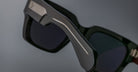 Close-up of Jacques Marie Mage Enzo black rectangular sunglasses with thick, textured frames, front view.