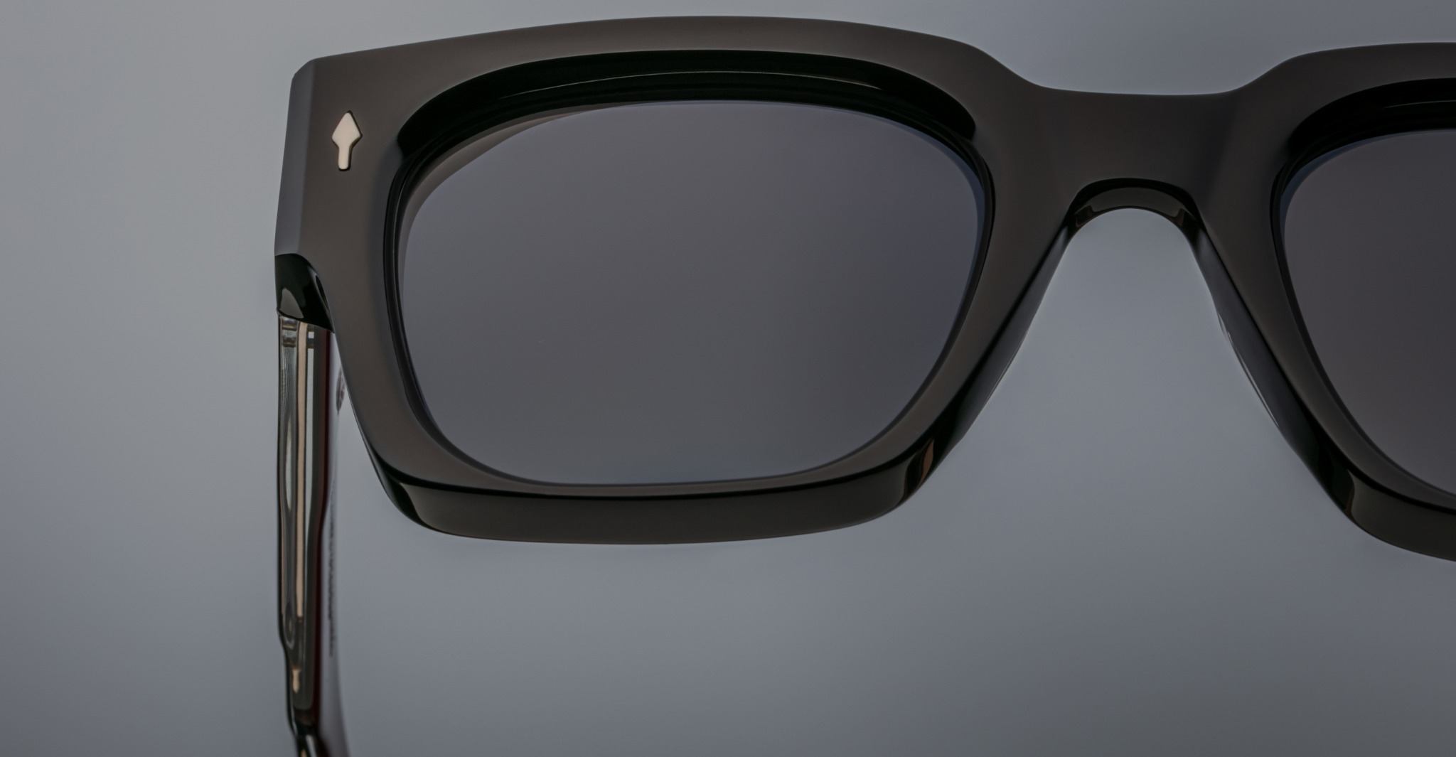 Close-up of left side of Jacques Marie Mage Enzo black square sunglasses with dark UV-protective lenses, side angle.