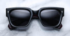 Jacques Marie Mage Enzo black rectangular sunglasses with dark lenses, front view.