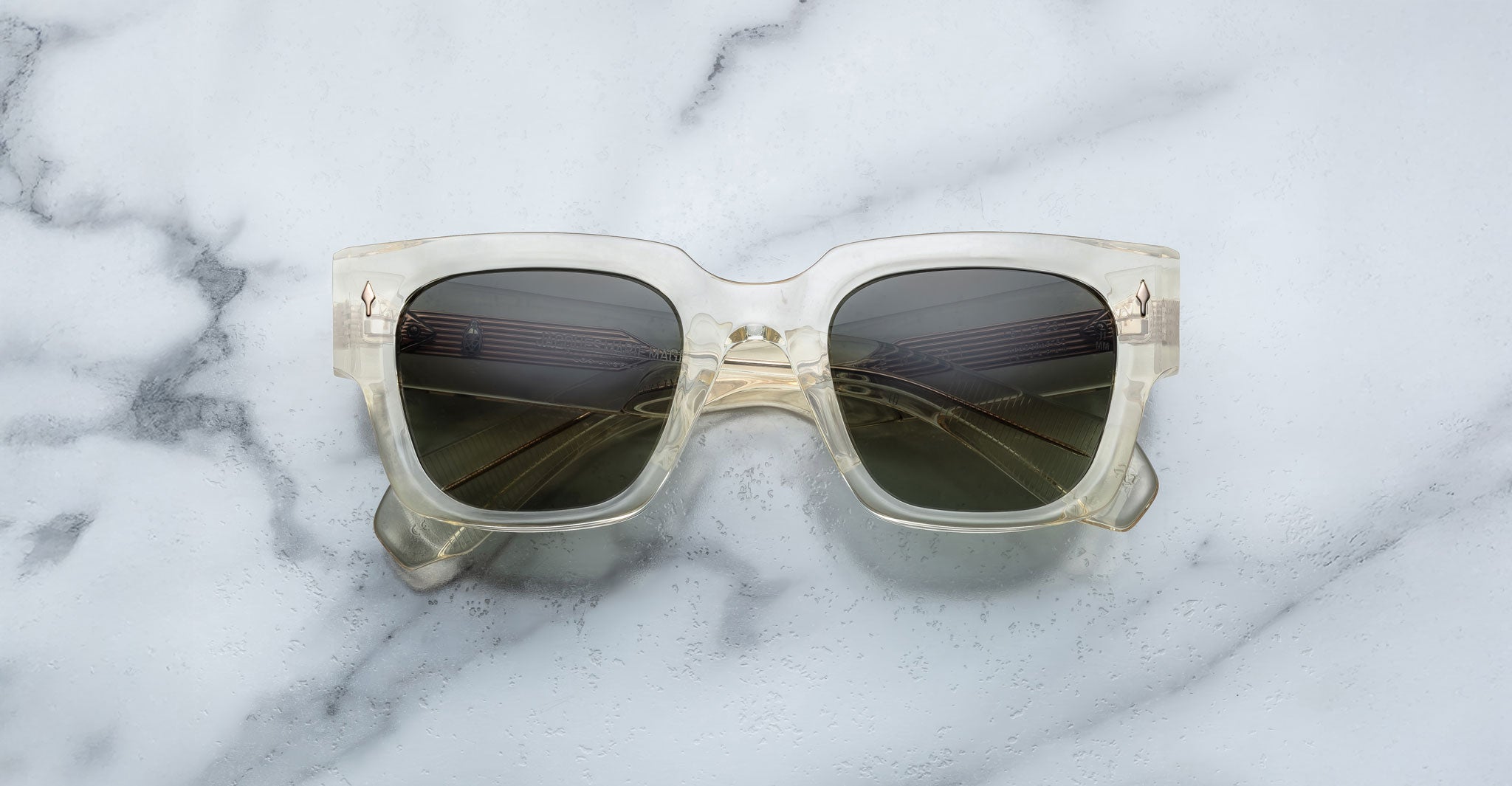 Jacques Marie Mage Enzo square sunglasses with dark UV lenses, front view, shown on a flat surface.