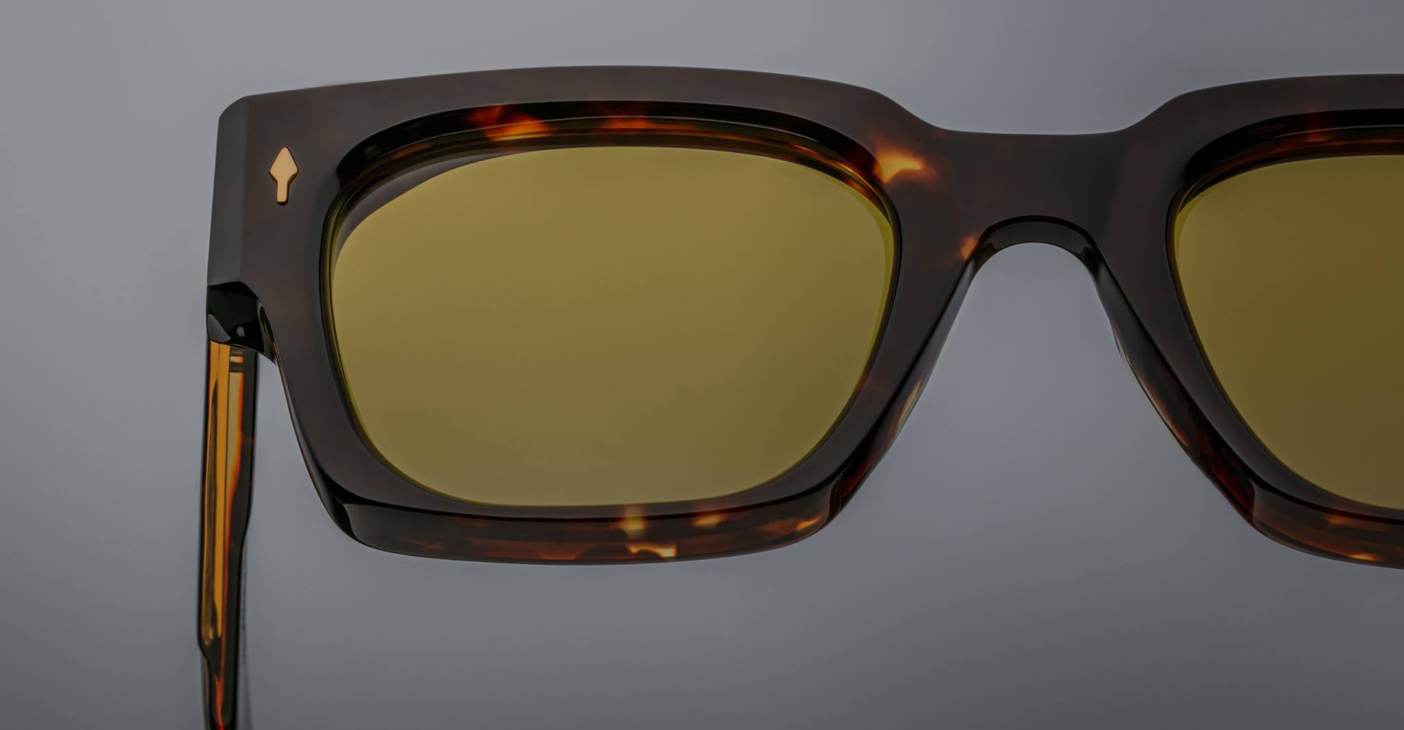 Close-up of Jacques Marie Mage Enzo sunglasses, tortoiseshell frame, yellow lenses, retro details, front angle.