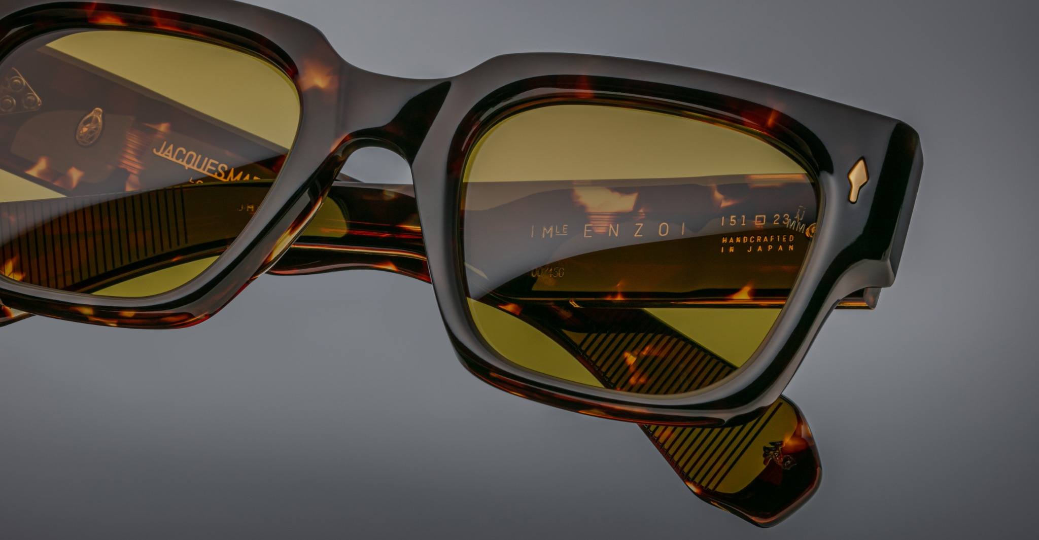 Close-up of Jacques Marie Mage Enzo tortoiseshell sunglasses, green lenses, showing branded inner arms.