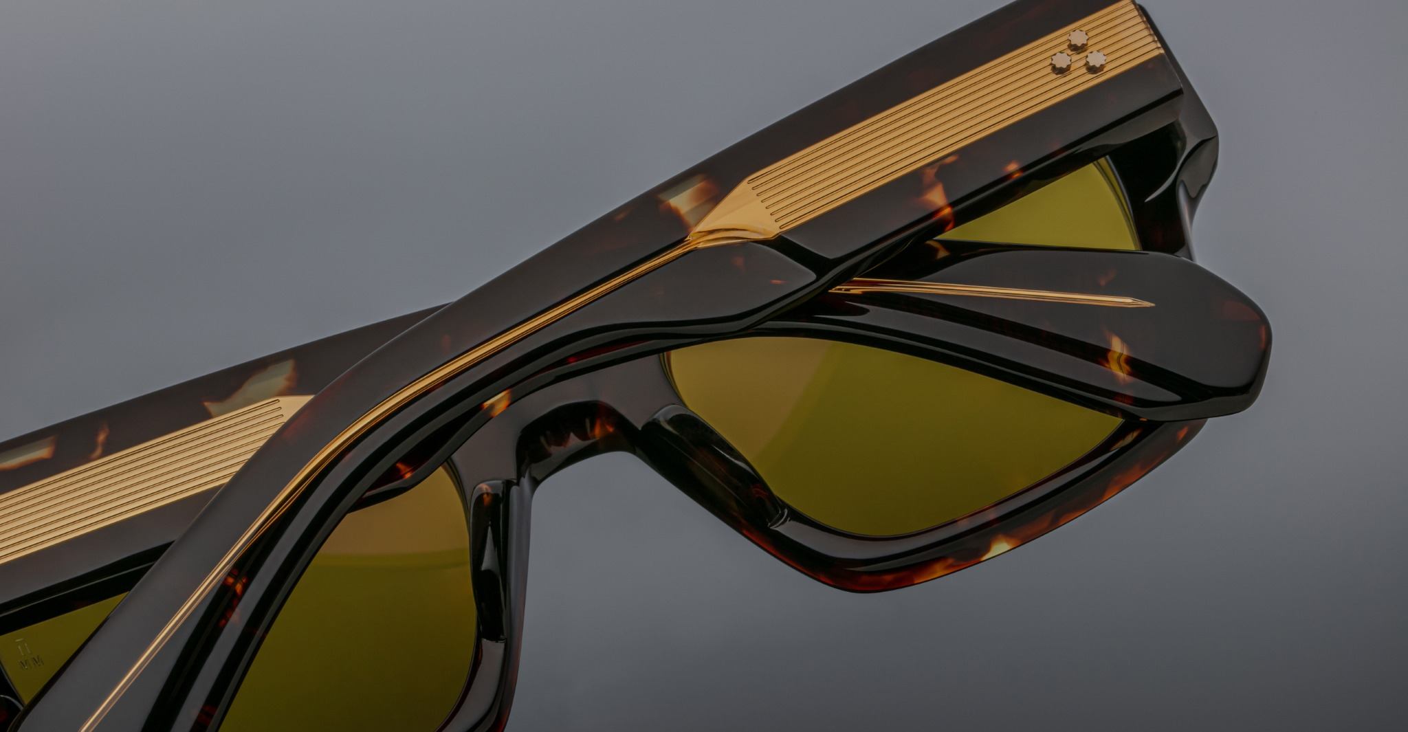 Jacques Marie Mage Enzo tortoiseshell sunglasses with yellow lenses, stacked, shown from a side angle.