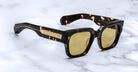 Jacques Marie Mage Enzo sunglasses, tortoiseshell frame, yellow lenses, gold accents, shown from above.