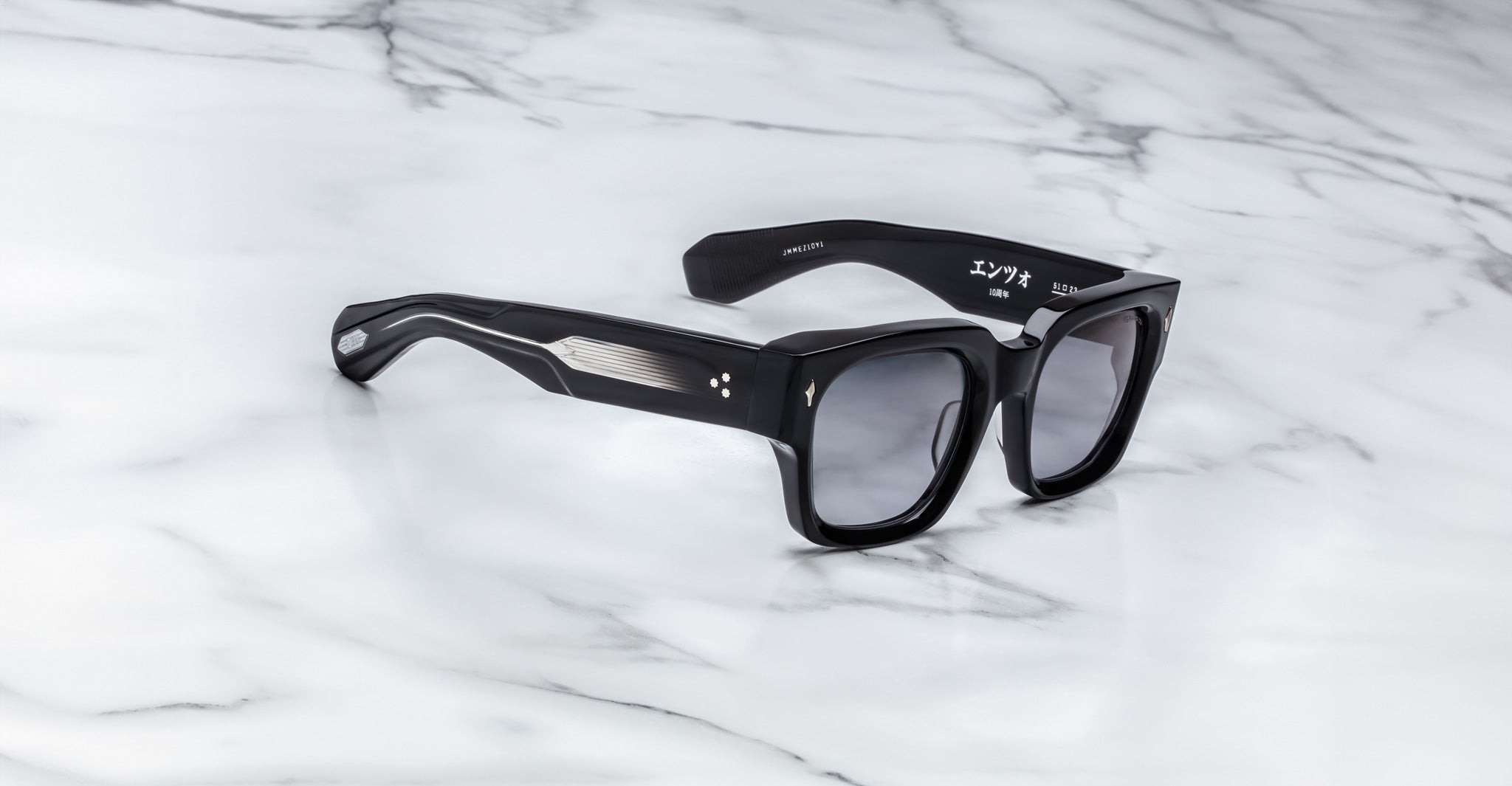 Jacques Marie Mage Enzo black rectangular sunglasses with thick frames and metallic accents, front angle view.