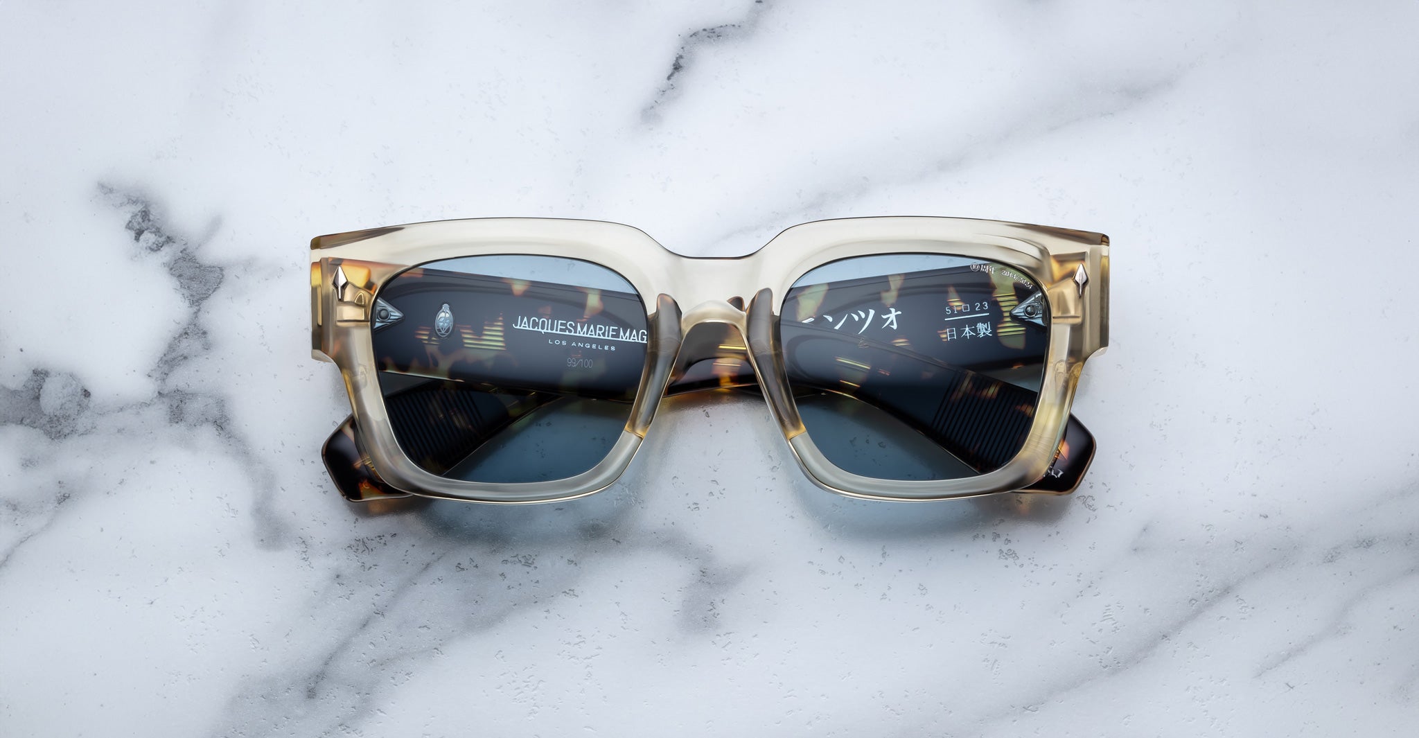 Jacques Marie Mage Enzo square sunglasses with dark lenses, viewed from above, showing the front frames and arms.