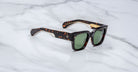 Jacques Marie Mage Enzo sunglasses with green lenses, viewed from above, display the frame and lens color clearly.