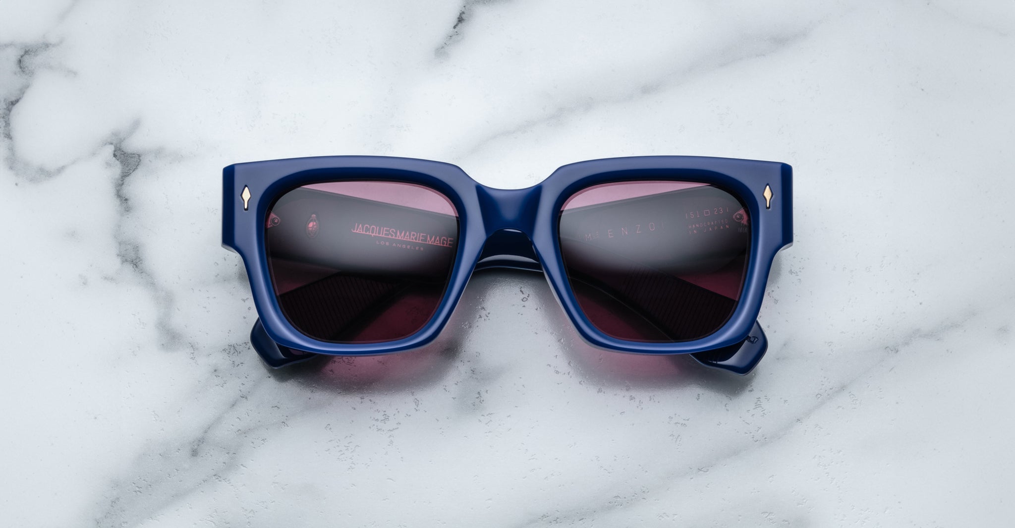 Jacques Marie Mage Enzo blue rectangular sunglasses with dark lenses, viewed from above, display their modern frame design.