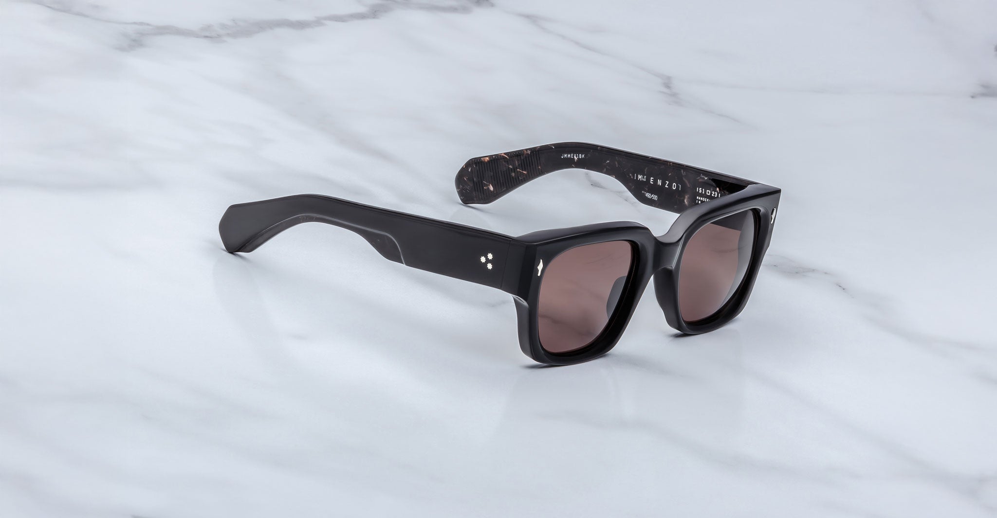 Jacques Marie Mage Enzo sunglasses, bold black rectangular frames with thick temples and dark lenses, shown from the front angle.